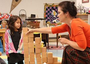 students learning math concepts with Montessori decimal system beads